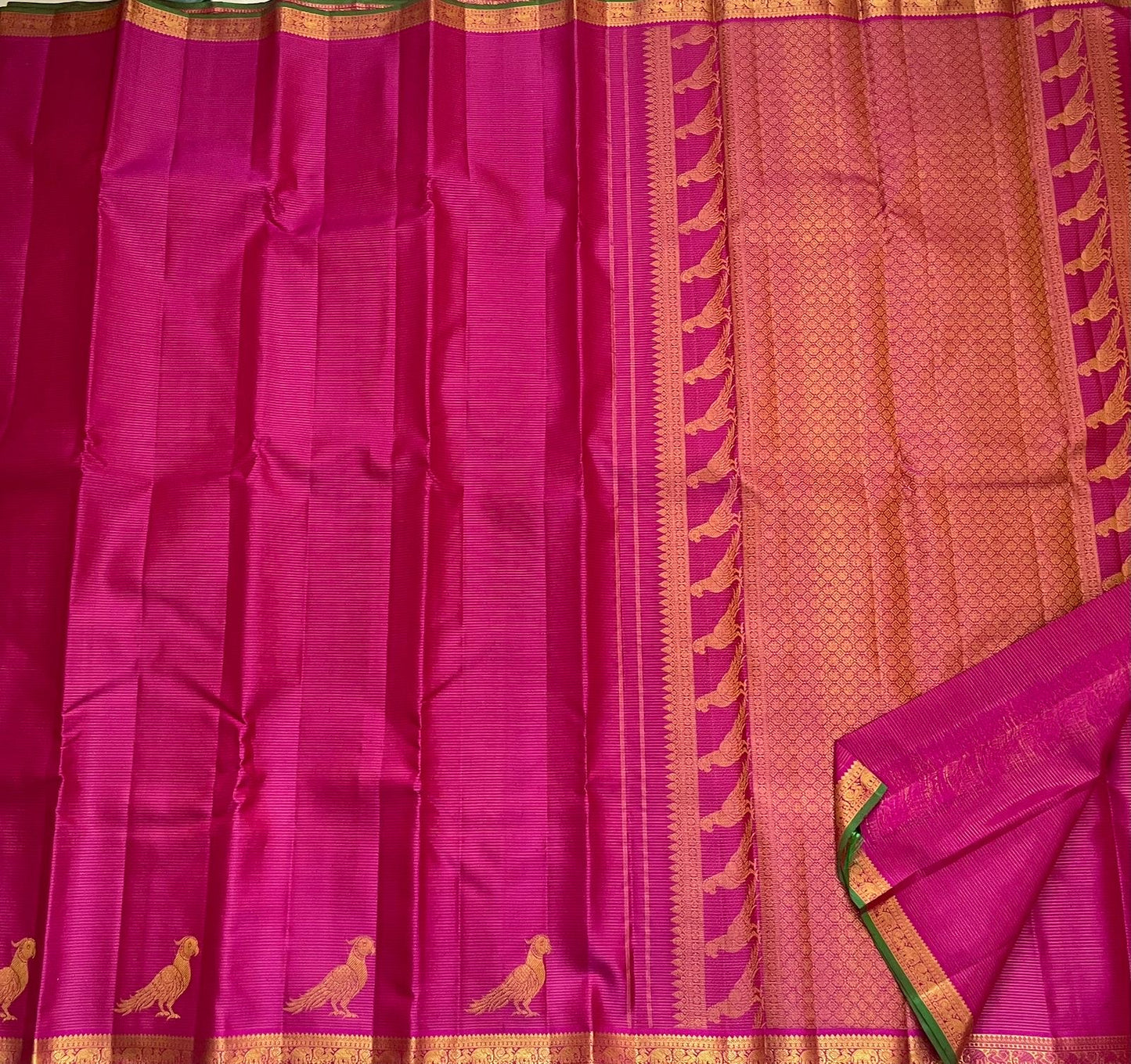 Detail of fine Vairaoosi zari lines woven continuously across deep magenta Kanchi Pattu pure silk body