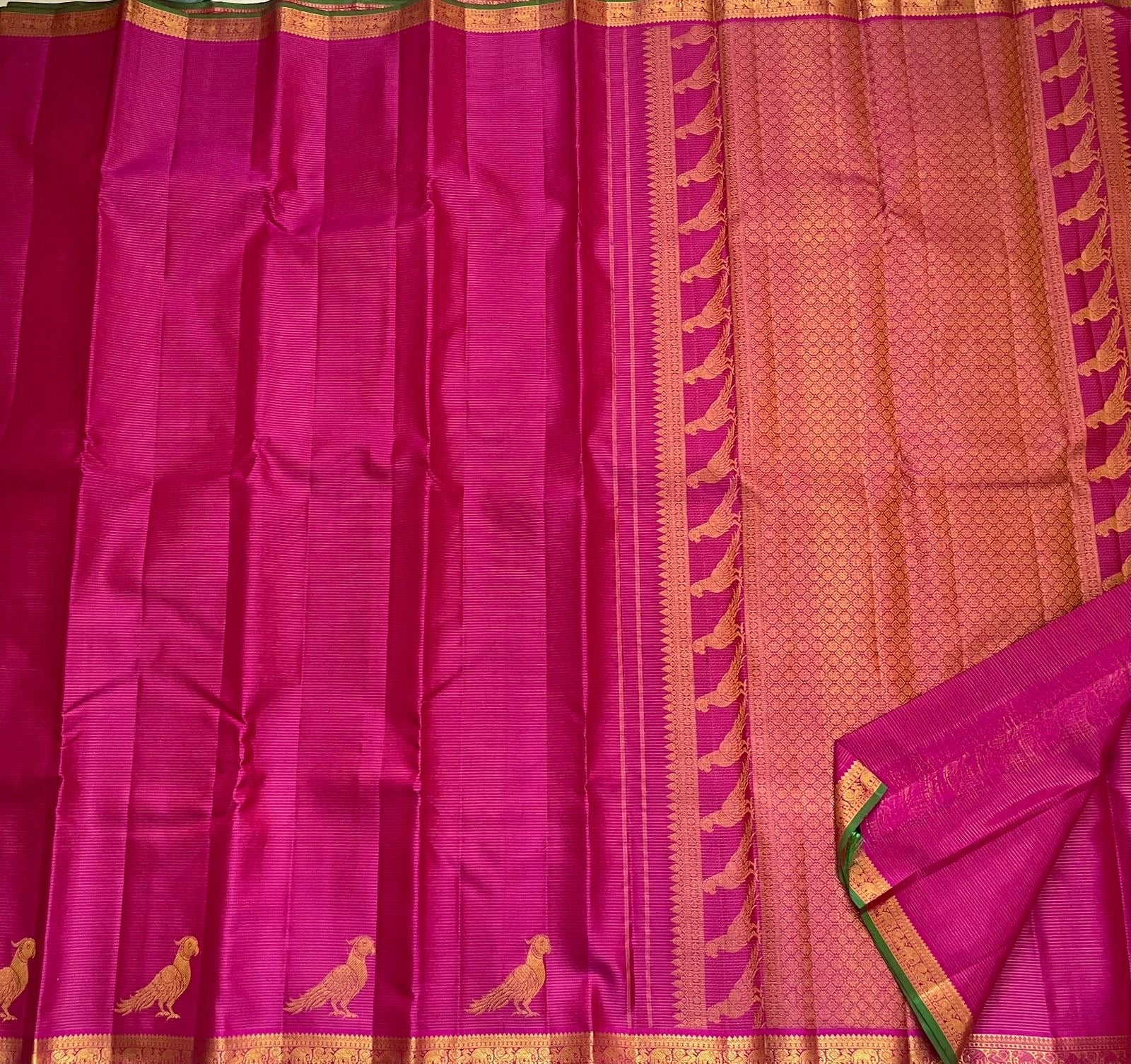 Detail of fine Vairaoosi zari lines woven continuously across deep magenta Kanchi Pattu pure silk body