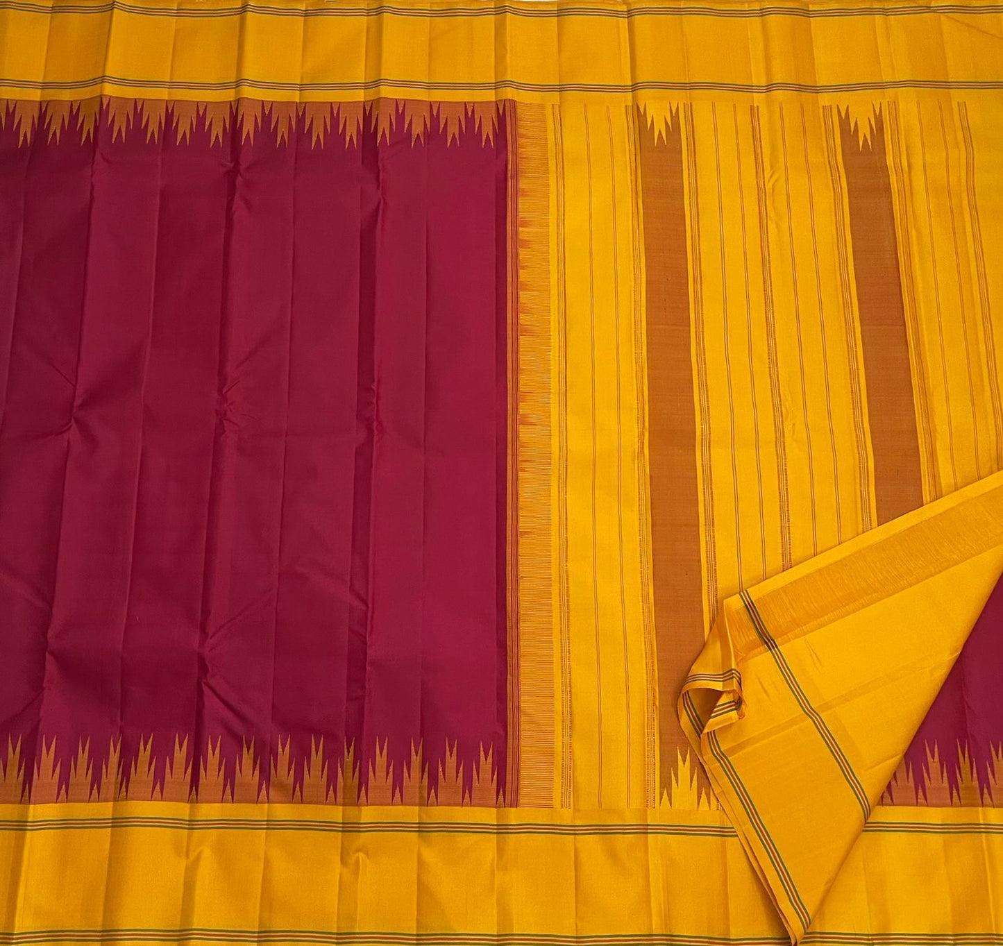Deep arakku red and canary yellow Kancheepuram silk saree folded showing Pattupet body and contrast canary yellow Korvai border