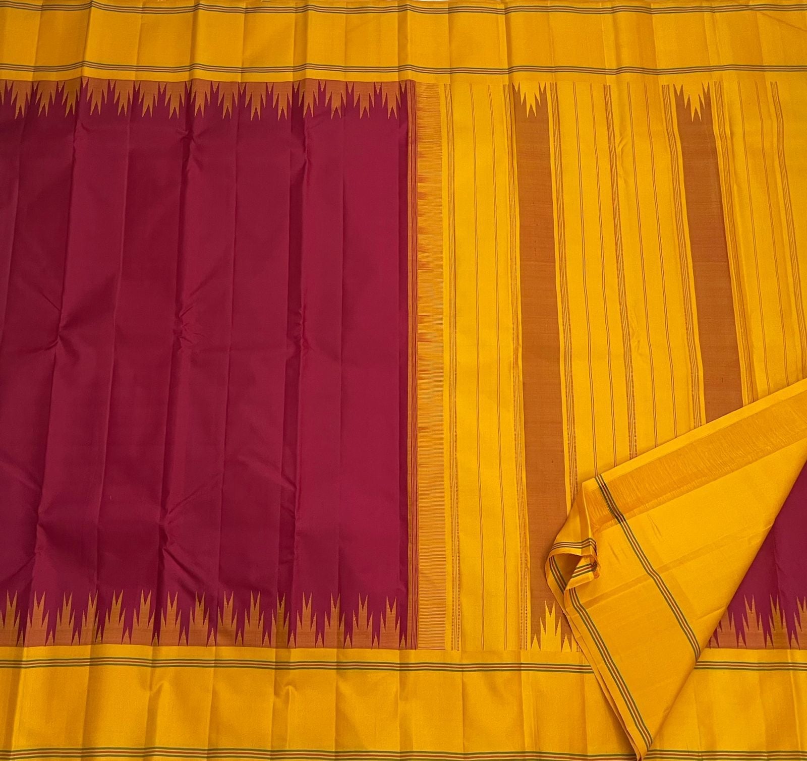 Deep arakku red and canary yellow Kancheepuram silk saree folded showing Pattupet body and contrast canary yellow Korvai border