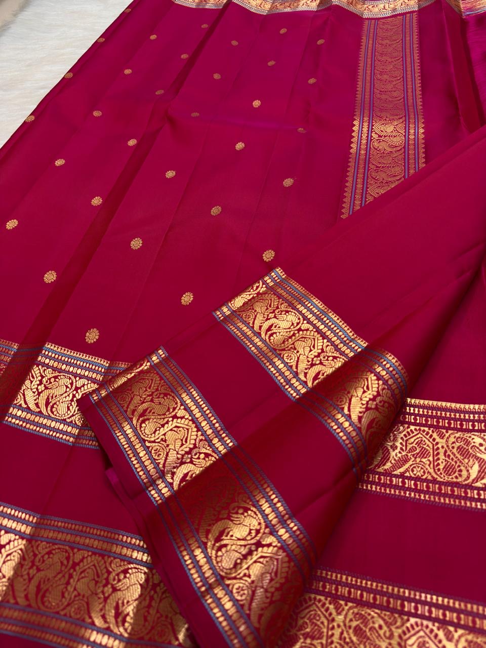 Deep Magenta Kanjivaram silk saree with warm gold zari peacock border