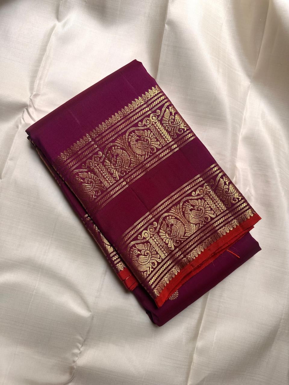 Close view of the peacock archway border on a fuchsia Kanchi Pattu saree