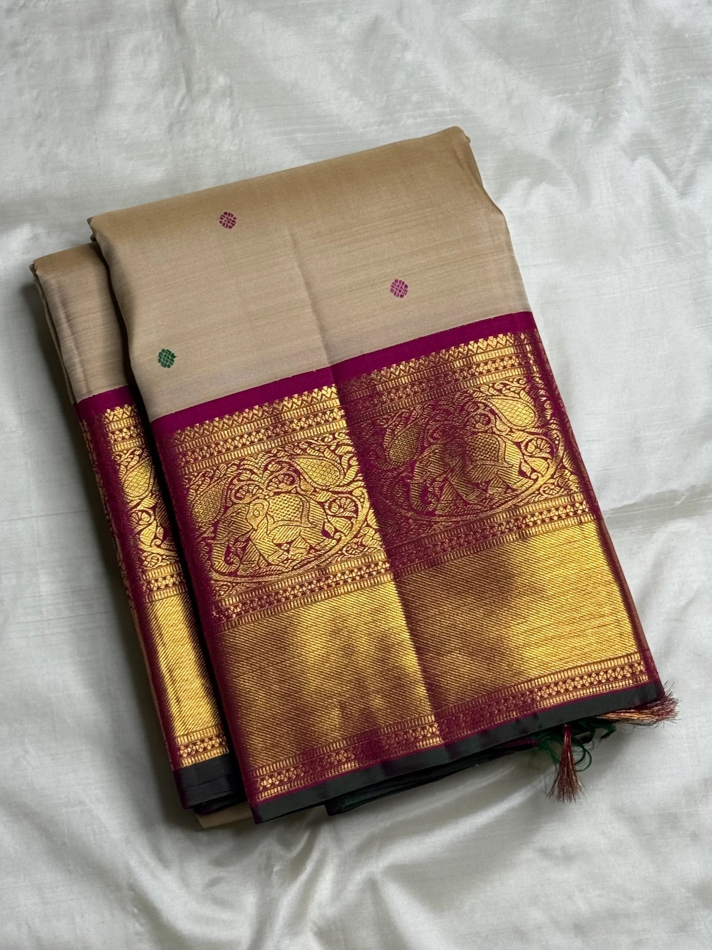 Detailed view of the zari border with elephant motifs on the Deep Magenta Korvai border