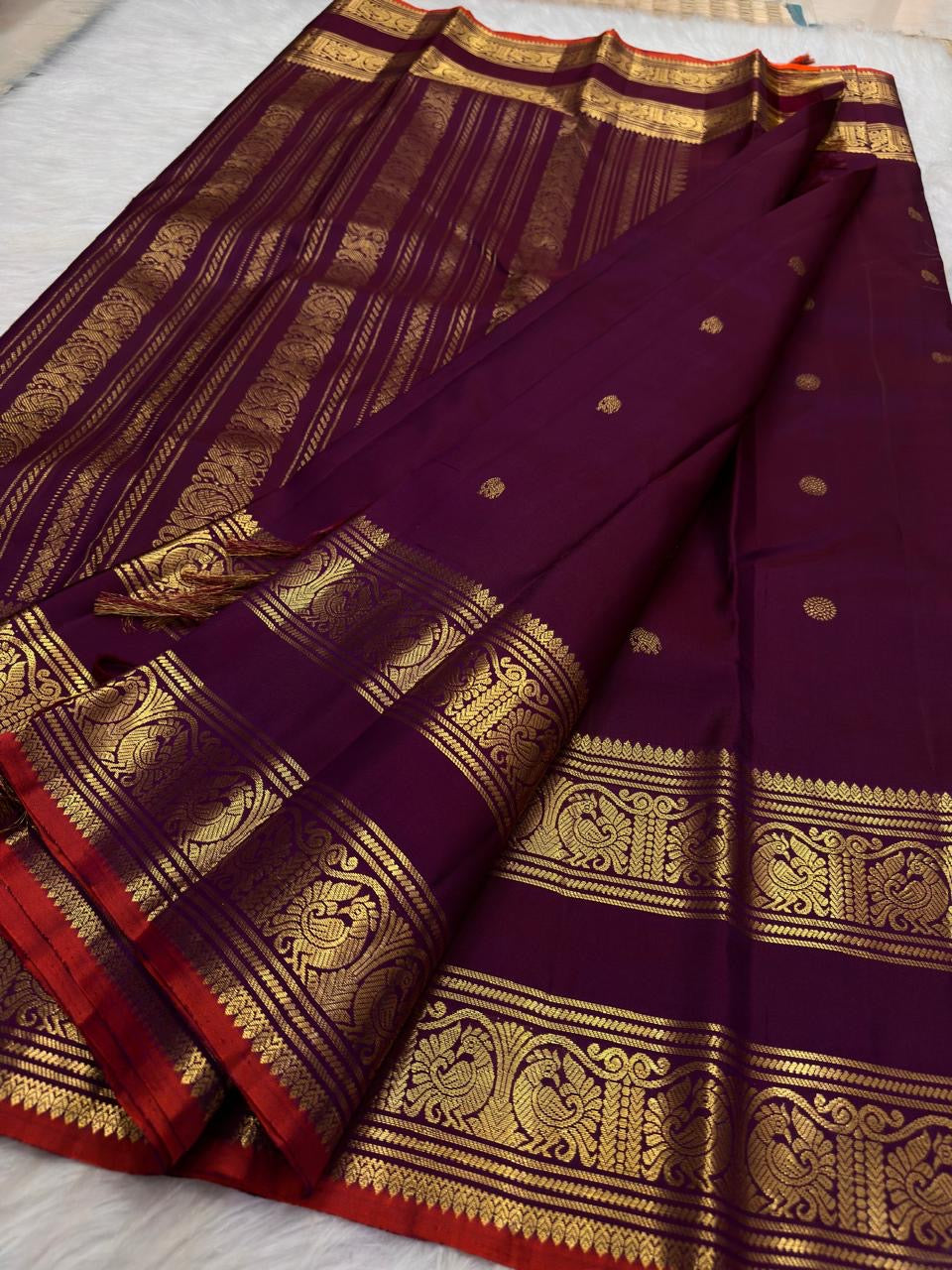 Fuchsia Kanchi Pattu saree with softly scattered gold zari buttas