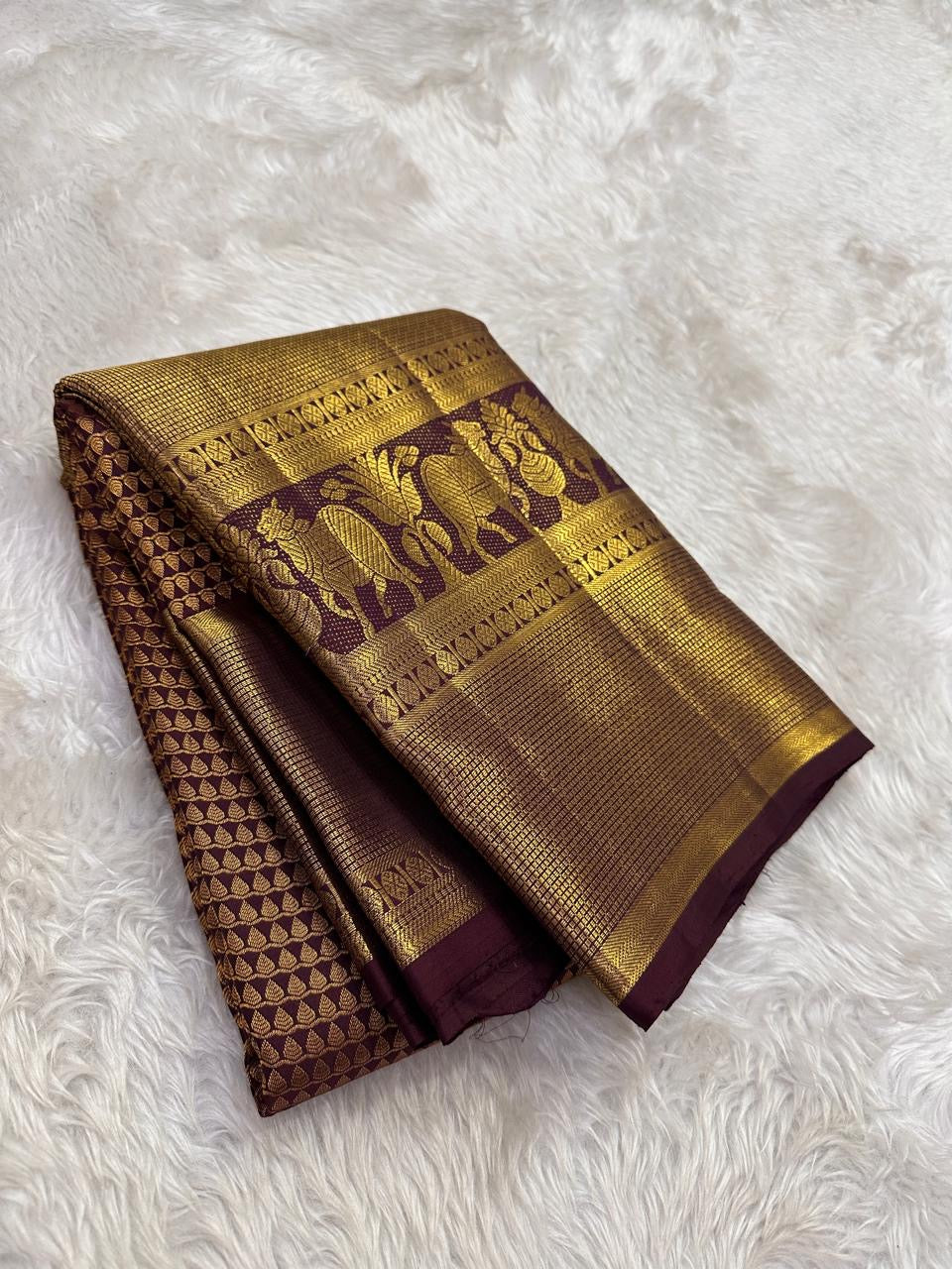 Handwoven maroon brown Kanchipuram silk with grand traditional elephant zari border.