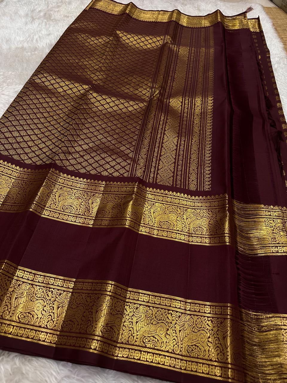 Grand pallu with gold zari elephants on deep maroon Kanjipuram silk saree