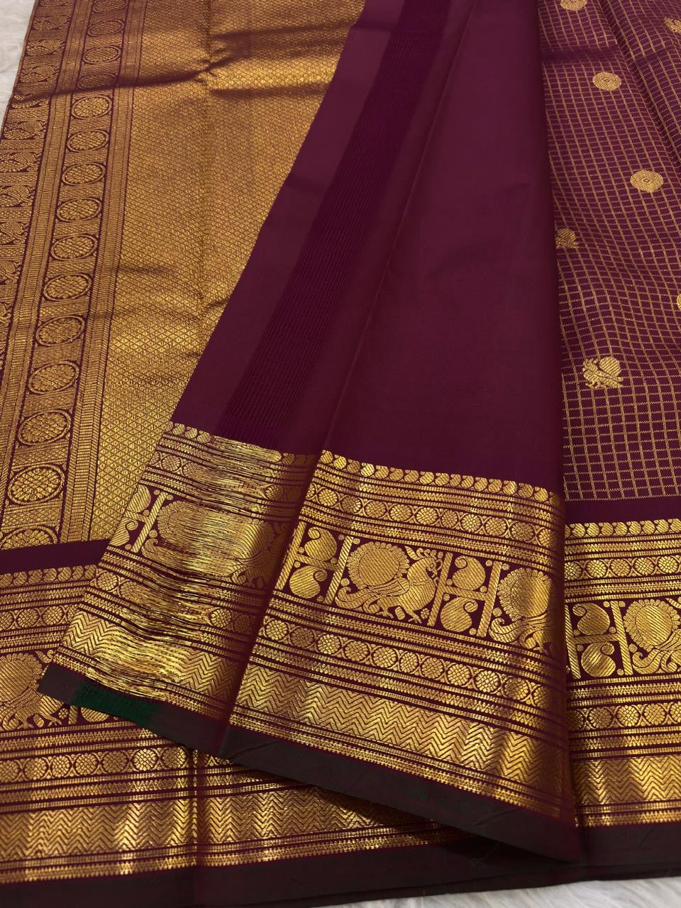 Deep maroon Kanjeevaram saree with Mayil pallu