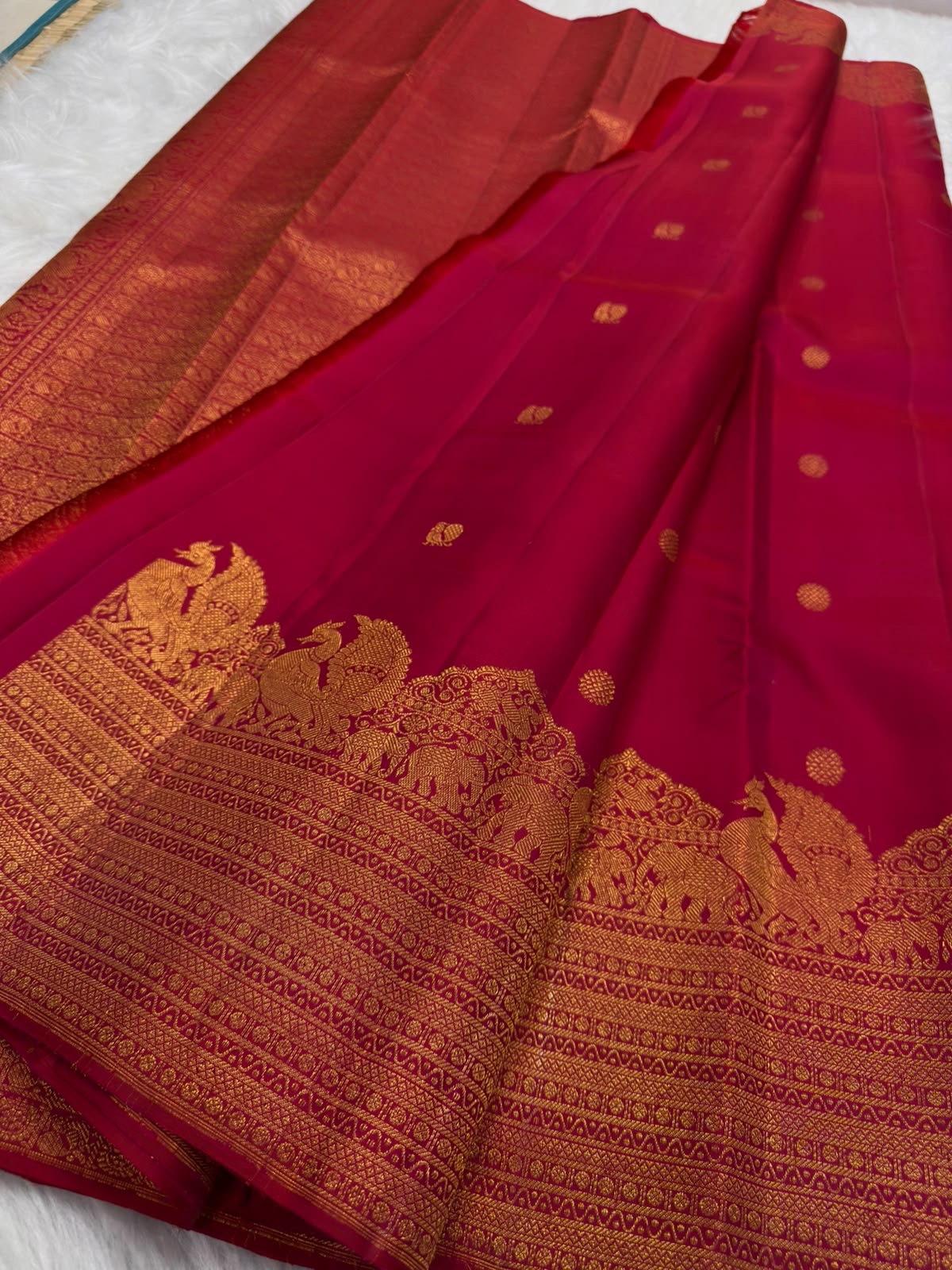 Deep Maroon Kanjivaram silk saree body close-up with gold zari floral butta motifs