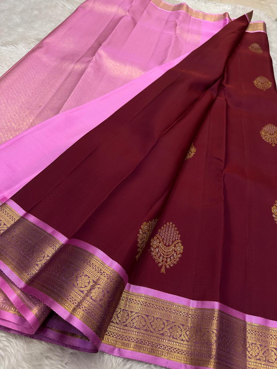 Pure Silk Kanjivaram saree in deep maroon with repeating zari buttas