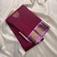 Deep maroon handwoven Pure Silk Kanchipuram butta saree folded to show the petal-pink border