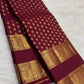 Maroon Kanchipuram saree with dense petite gold buttas