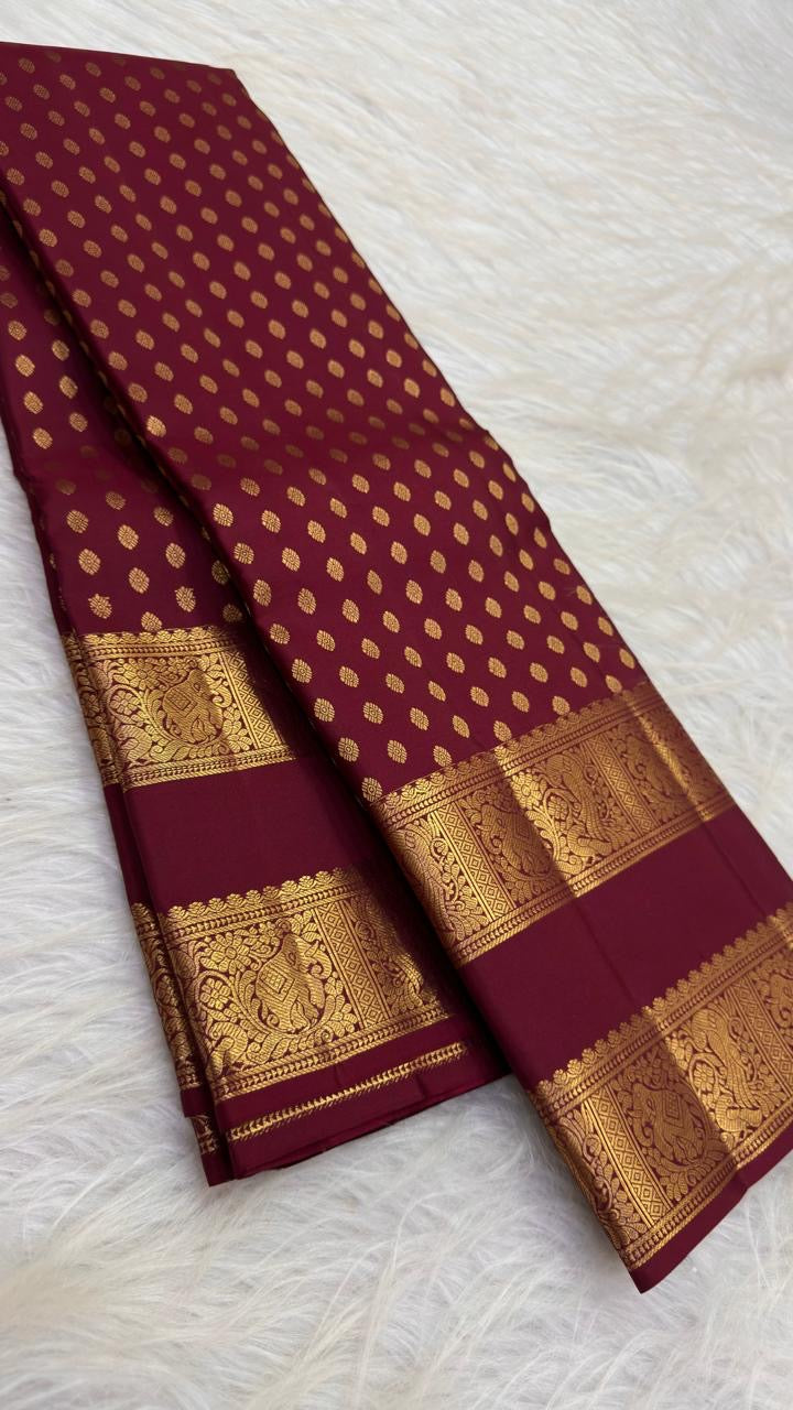 Maroon Kanchipuram saree with dense petite gold buttas