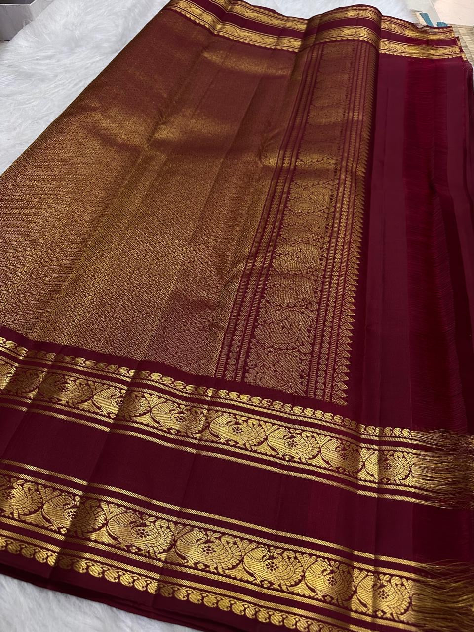 Deep maroon Kanchipuram silk saree with Annam border, close-up