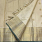 Warm ivory Kanjipuram silk saree with pale-gold zari kattam and green edging, folded view — Idam Living