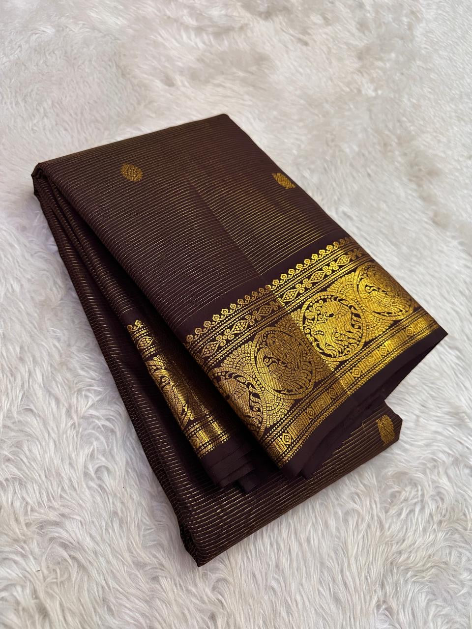 Self-colour pallu of deep coffee brown Kanjipuram pure silk saree with cascading Mayil peacock antique gold zari