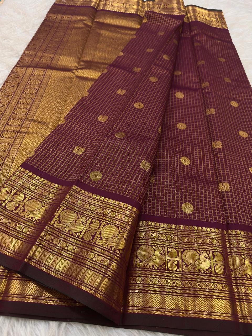 Deep maroon Kanjivaram saree with ornate gold border
