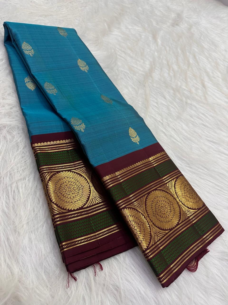 Deep Maroon Kanchipuram border with Peacock Green bands and gold lotus medallions