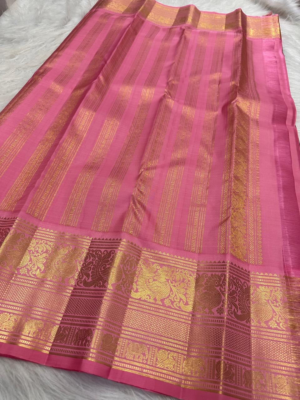 Deep maroon Pure Silk Kanchipuram saree with a broad pink zari border.