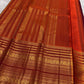 Rust orange Varisaipet border with red silk thread woven motifs on deep maroon Kanchipuram saree