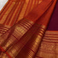 Rust orange pallu with red silk thread motifs on deep maroon Varisaipet Kanchipuram saree