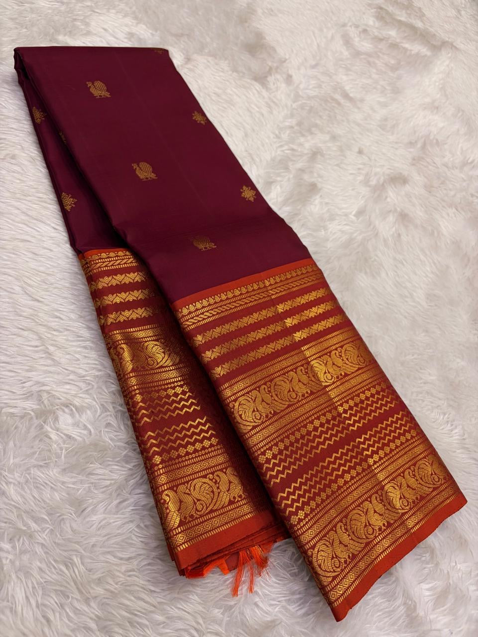 Close view of Varisaipet body showing Mayil Butta in gold zari on deep maroon silk