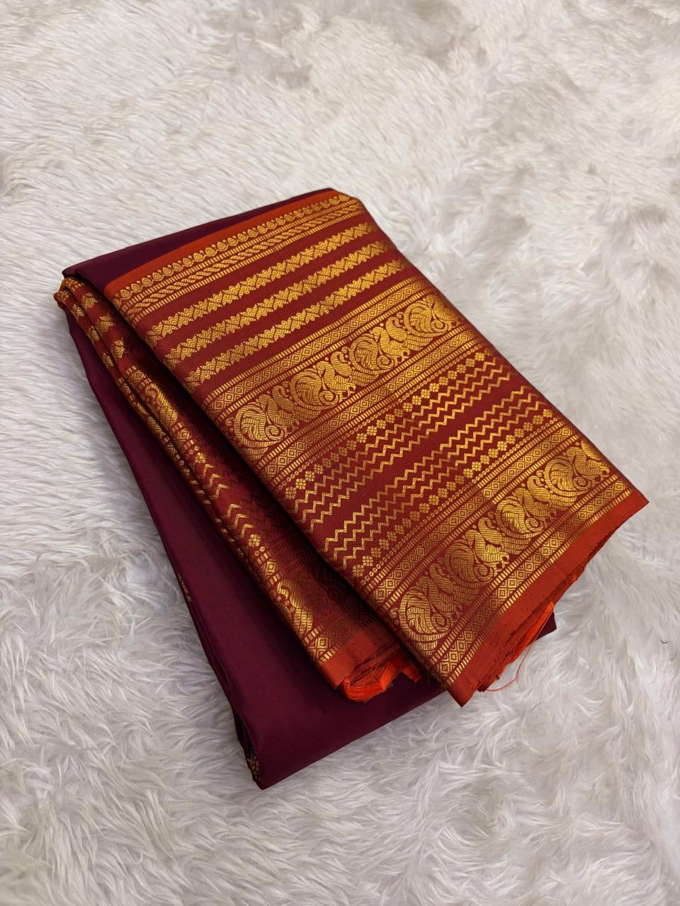 Mayil Butta peacock motif in gold zari on deep maroon Varisaipet body