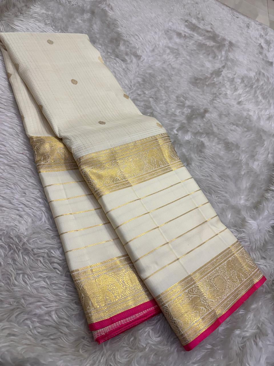 Antique-gold Mayil border with botanical detailing on Warm Ivory Kanchipuram silk.