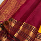 Close view of deep Maroon Korvai border and pallu with elaborate stacked gold zari ornamental registers.