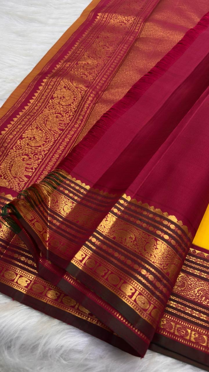 Close view of deep Maroon Korvai border and pallu with elaborate stacked gold zari ornamental registers.