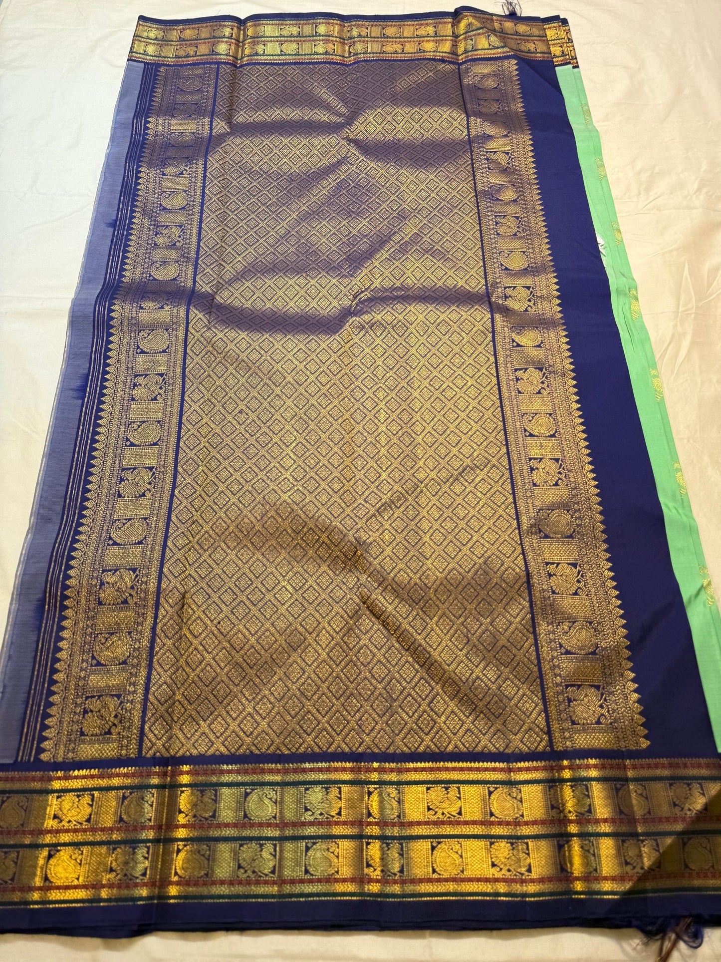 Folded view of jade green and deep navy butta korvai Kanchipuram silk saree — Idam Living