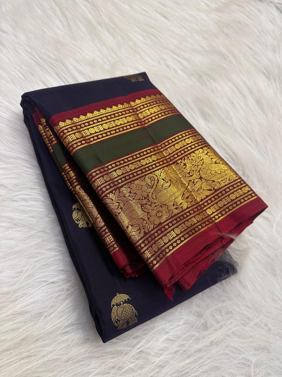Deep navy Kanchi Pattu saree with handwoven elephant zari buttas — Idam Living.
