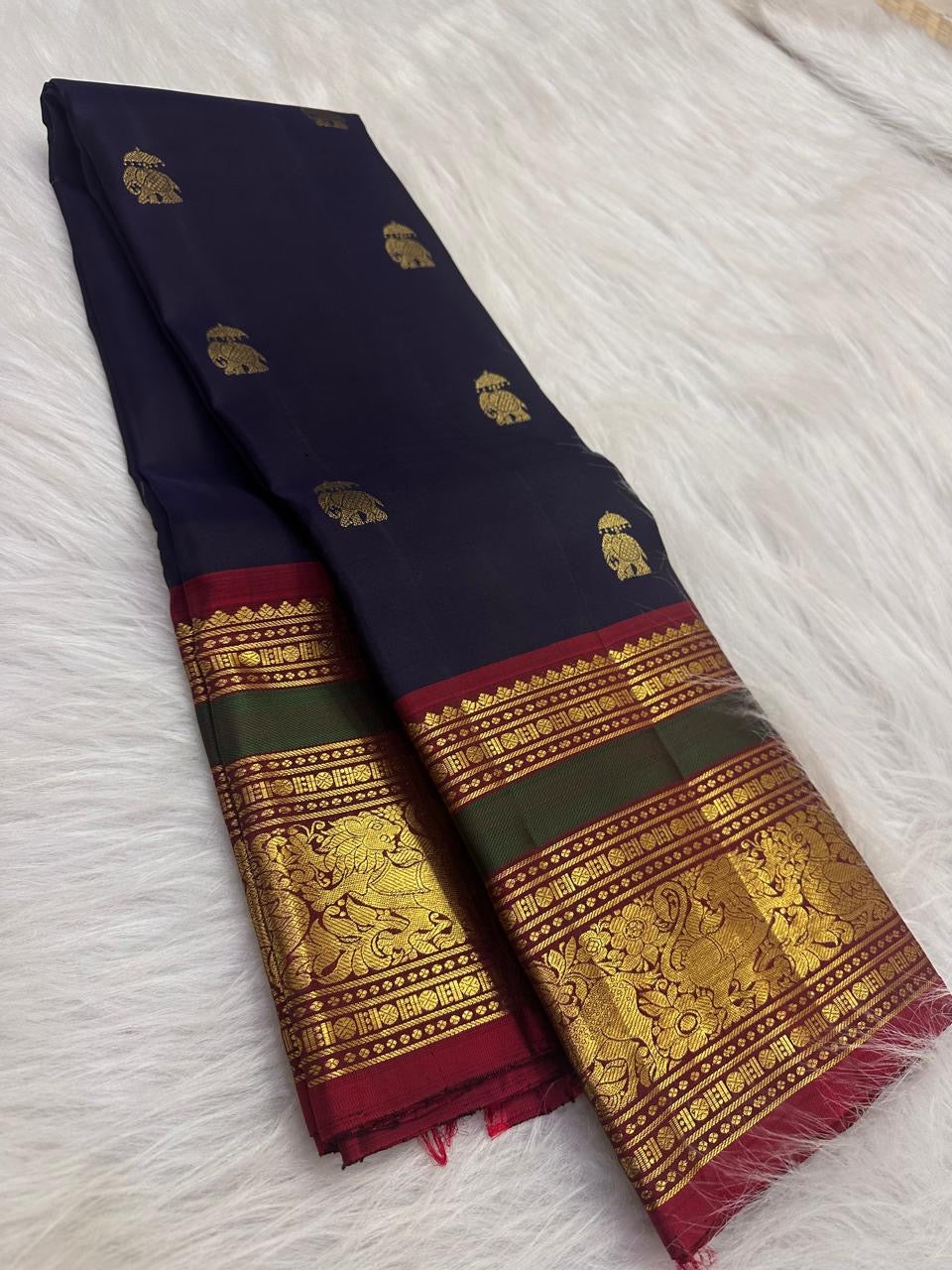 Close-up of elephant zari buttas on the deep navy Kanchi Pattu silk saree.