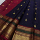Deep navy Kanchi Pattu saree showing the contrast maroon-olive zari border.