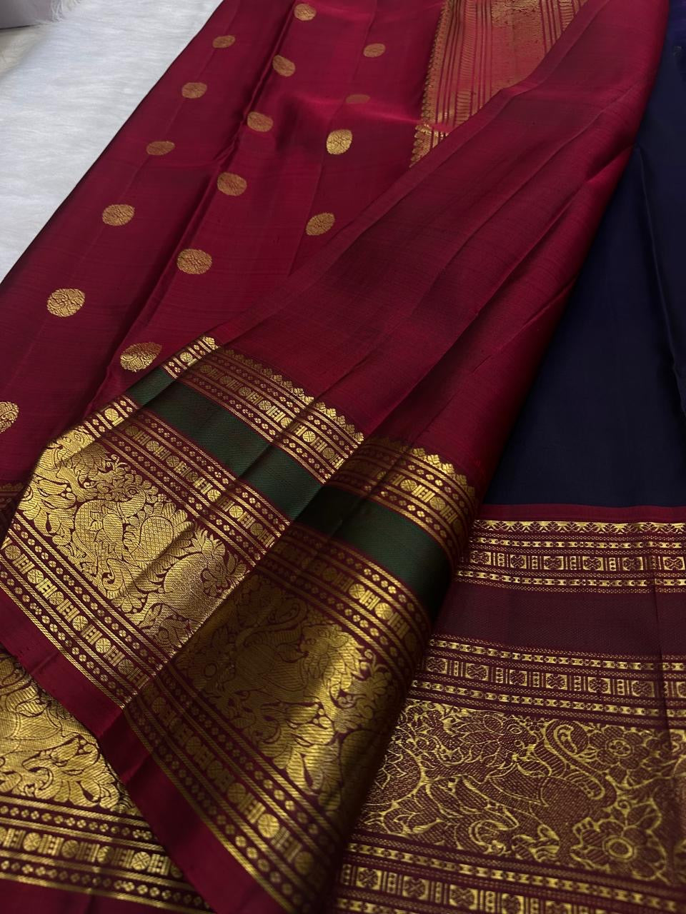 Handwoven deep navy Kanchi Pattu saree, full drape with elephant motifs.