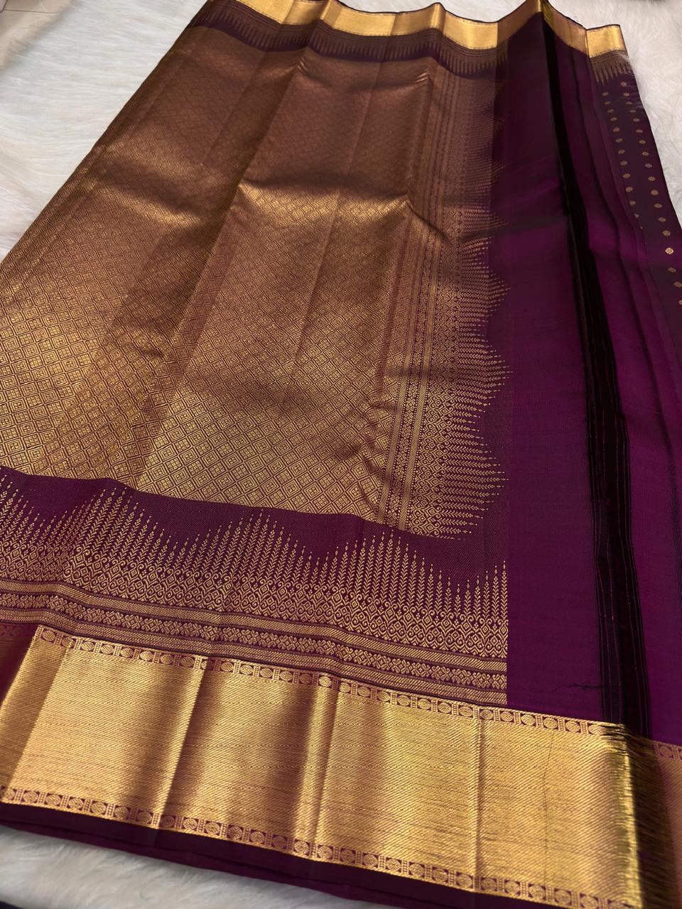 Handwoven Plum Purple Kanchipuram silk saree with rows of petite gold zari motifs