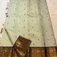 Deep purple Kanchana border with dense gold zari peacock panels on pistachio green saree — Idam Living
