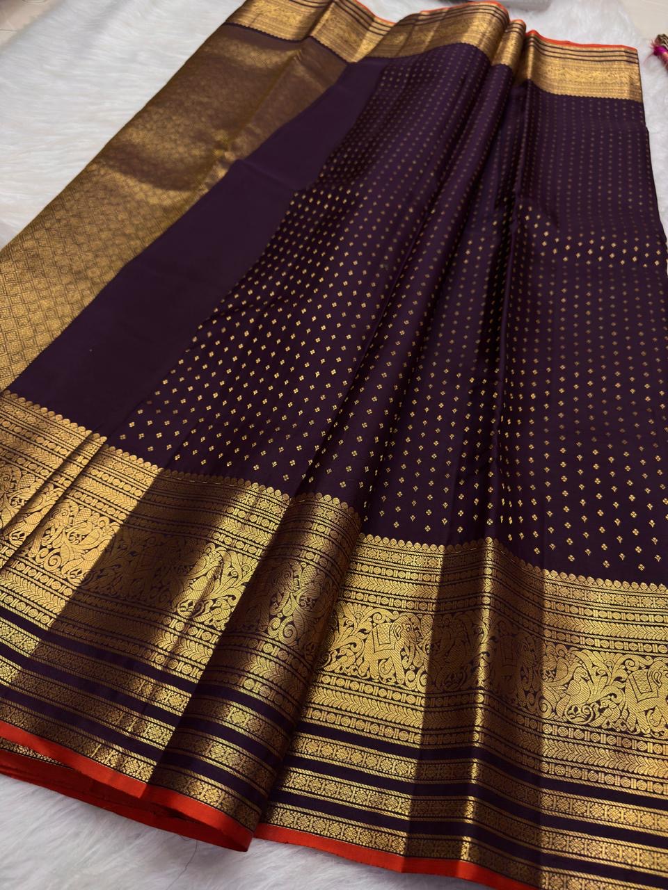 Close view of fine antique-gold zari buttas on Deep Aubergine Purple Kanjivaram silk.
