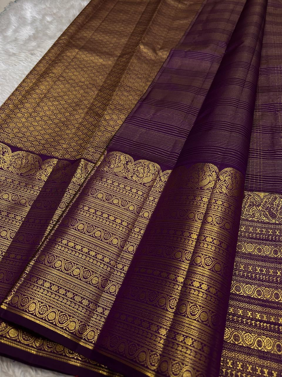 Folded Deep Aubergine Purple Zari Kattam saree with petite gold buttas and broad multi-register gold zari border.