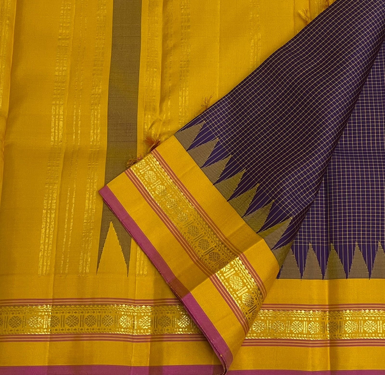 Deep Purple Kanjivaram silk saree with gold Zari Kattam grid folded to show the pallu