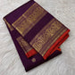 Deep-purple Pure Silk Kanchipuram saree with a peacock-plumage Rettapet border, double zari bands, and orange selvedge.