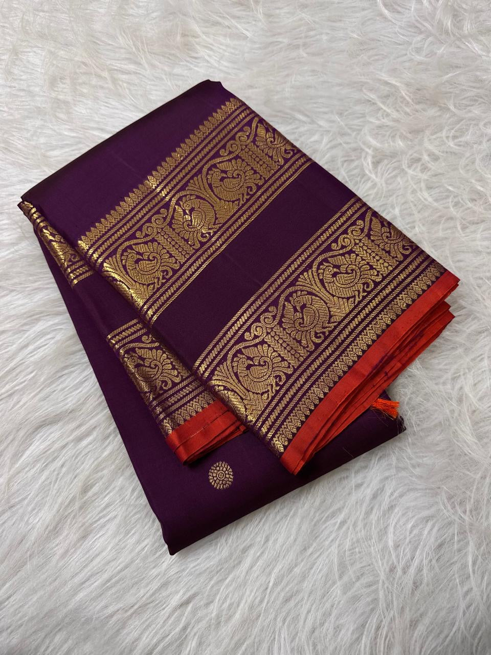Deep-purple Pure Silk Kanchipuram saree with a peacock-plumage Rettapet border, double zari bands, and orange selvedge.