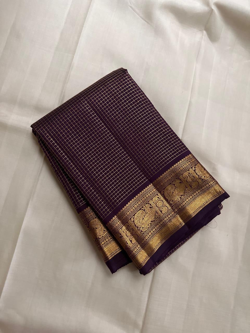 Close-up of deep purple Kanchipuram Zari Kattam silk saree body showing fine interlocking gold check weave — Idam Living