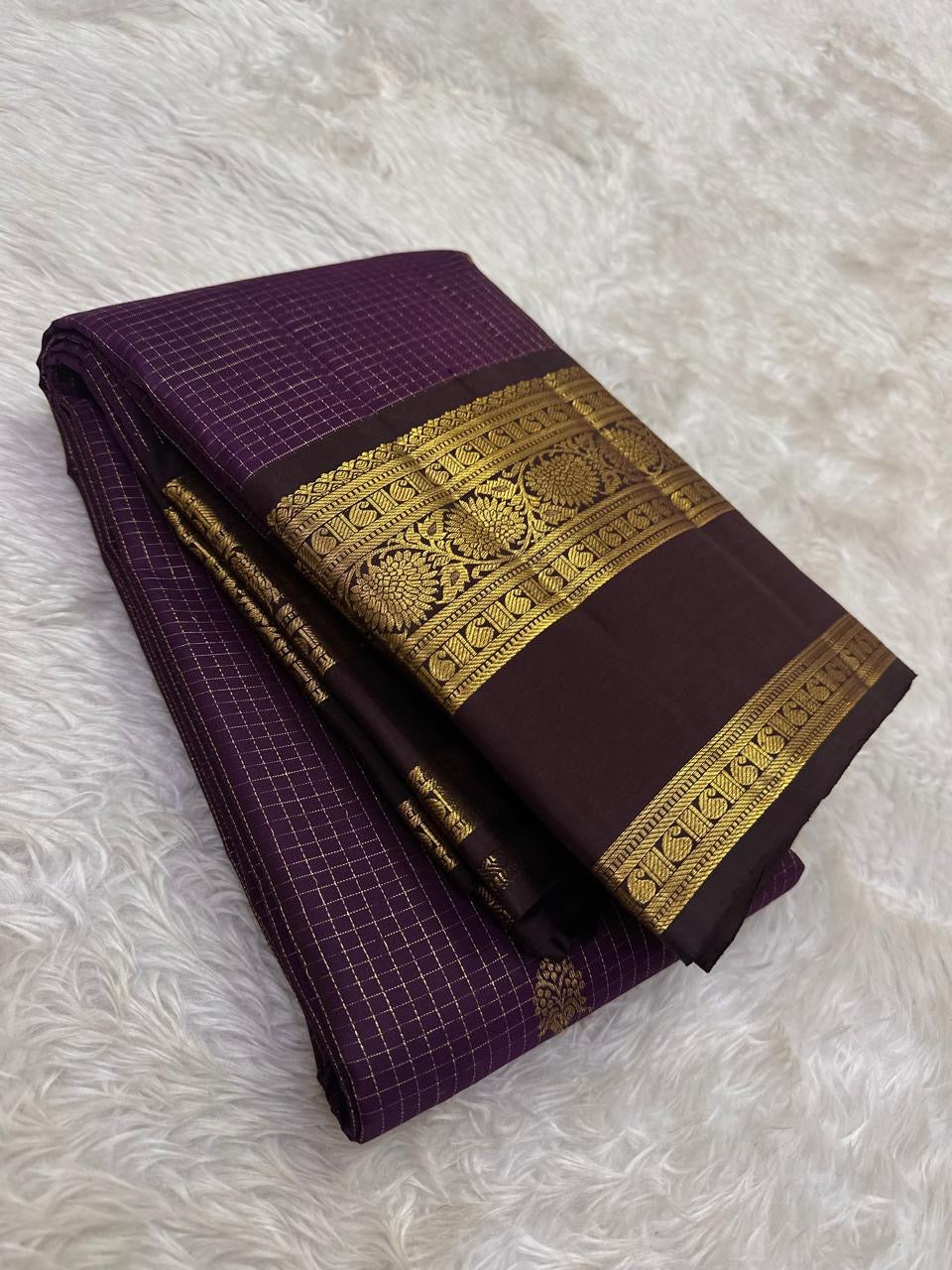 Deep purple Pure Silk Kanchipuram with fine gold Zari Kattam lines and scattered zari buttas.