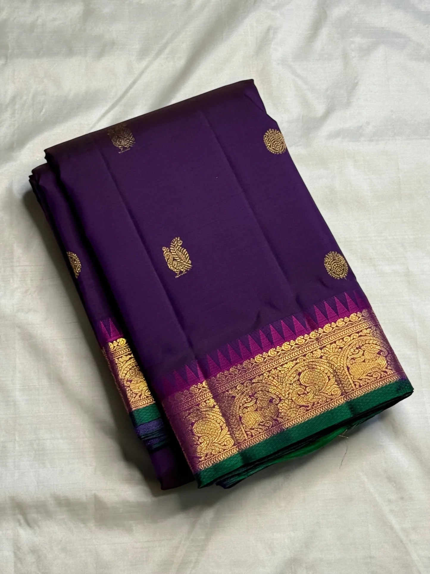 Close-up of mayil butta in gold zari on deep purple Kanjivaram silk saree — Idam Living