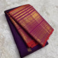 Rust orange pallu with red silk thread motifs on deep purple Varisaipet Kanchi Pattu saree