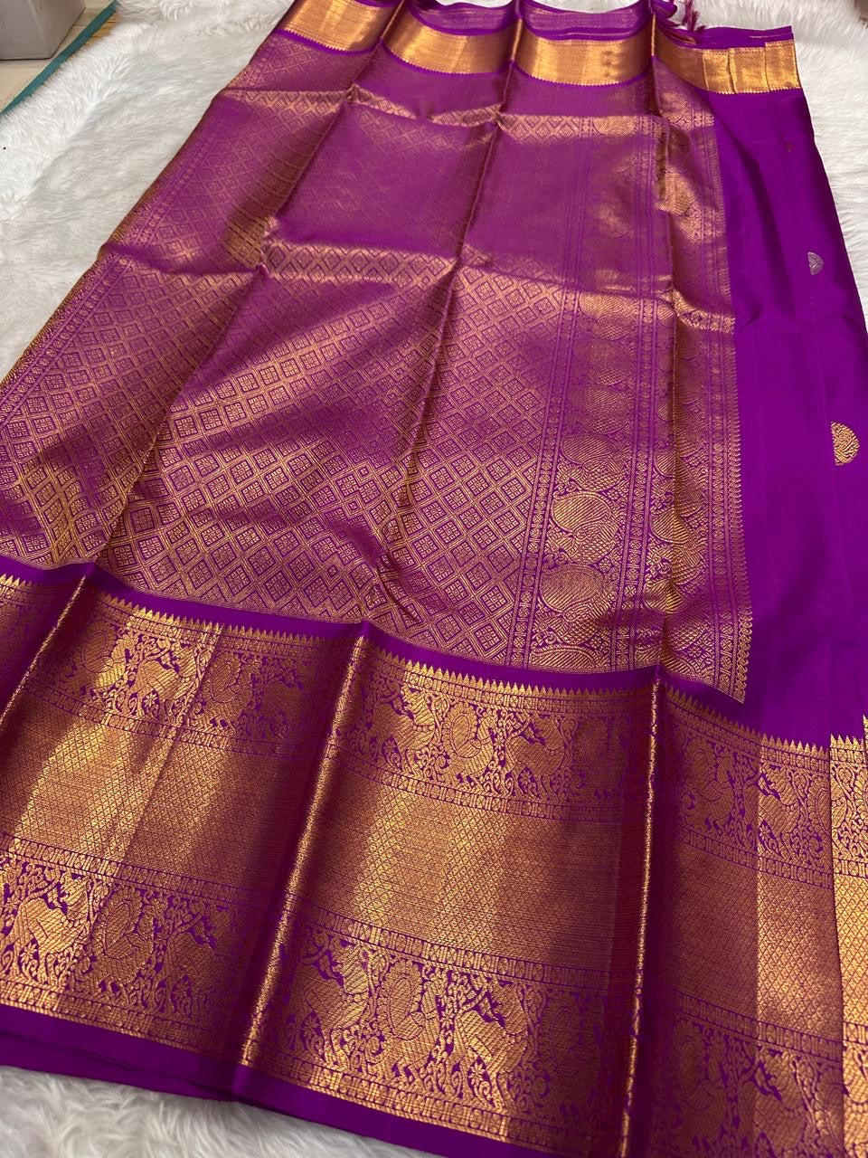 Deep purple pure Kanjivaram silk saree with traditional mayil butta