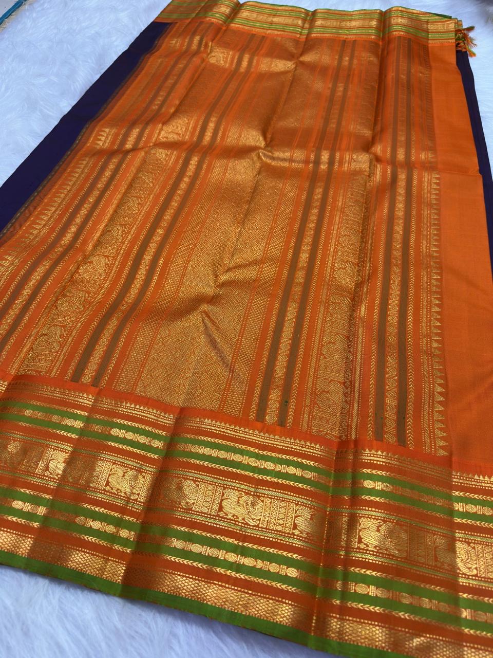 Deep Purple pure silk Kanjeevaram Varisaipet saree with Burnt Orange green and antique-gold zari border.