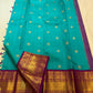 Open Turquoise Blue Pure Silk Korvai saree with scattered gold motifs and richly woven Deep Purple zari border.