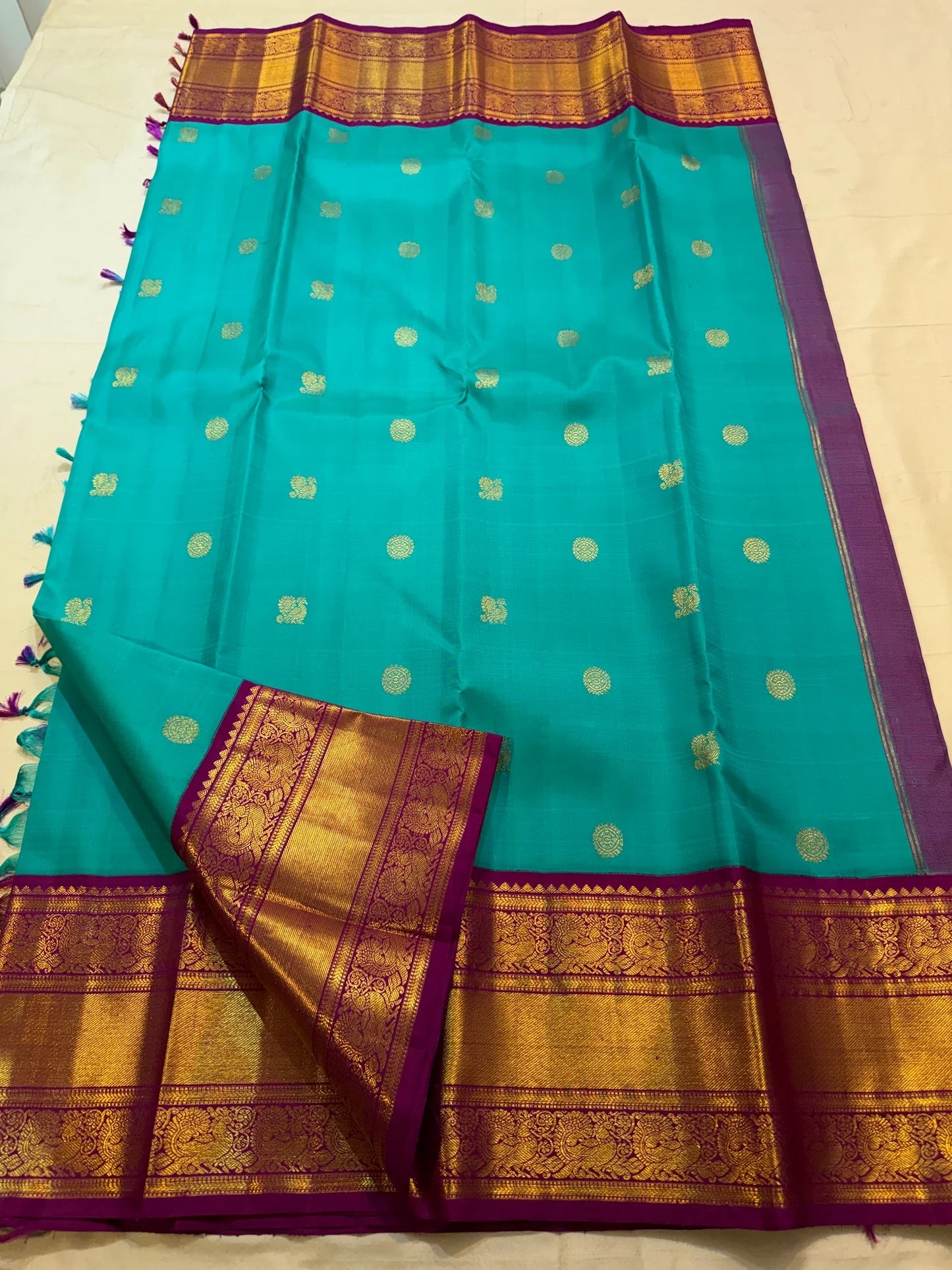 Open Turquoise Blue Pure Silk Korvai saree with scattered gold motifs and richly woven Deep Purple zari border.