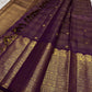 Layered classic-gold ornamental border against deep purple Kanchipuram silk.